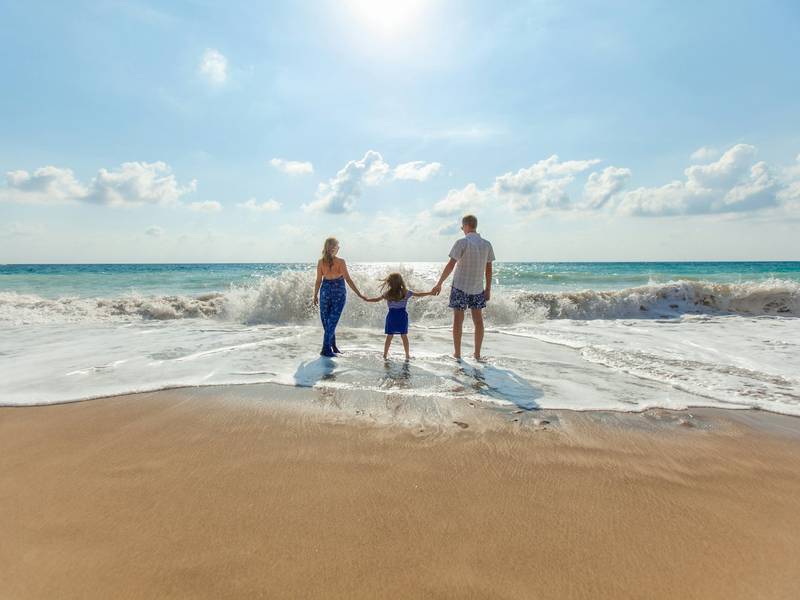 Family holding hands on a beach