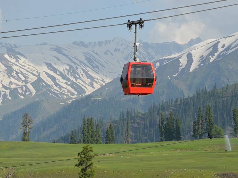 Red gondola cabin above the meadows of Gulmarg, Kashmir