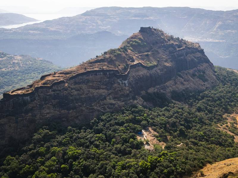 Hill fort rising above green valleys in the Sahyadri, Maharashtra