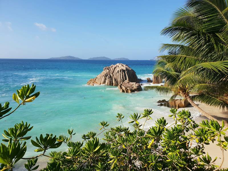 Granite boulders and clear water on a Seychelles beach