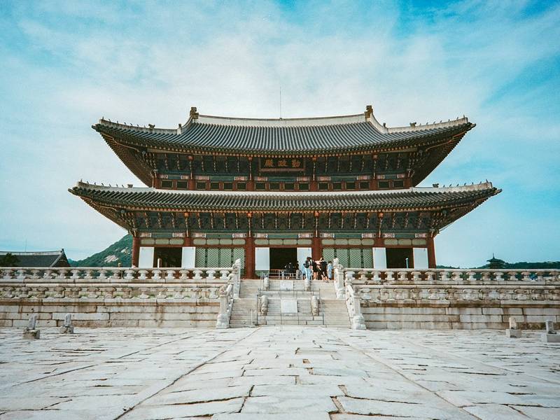 Gyeongbokgung Palace hall in Seoul under a blue sky